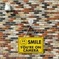 Smile You're on Camera Yellow Warning Sign (BS11)